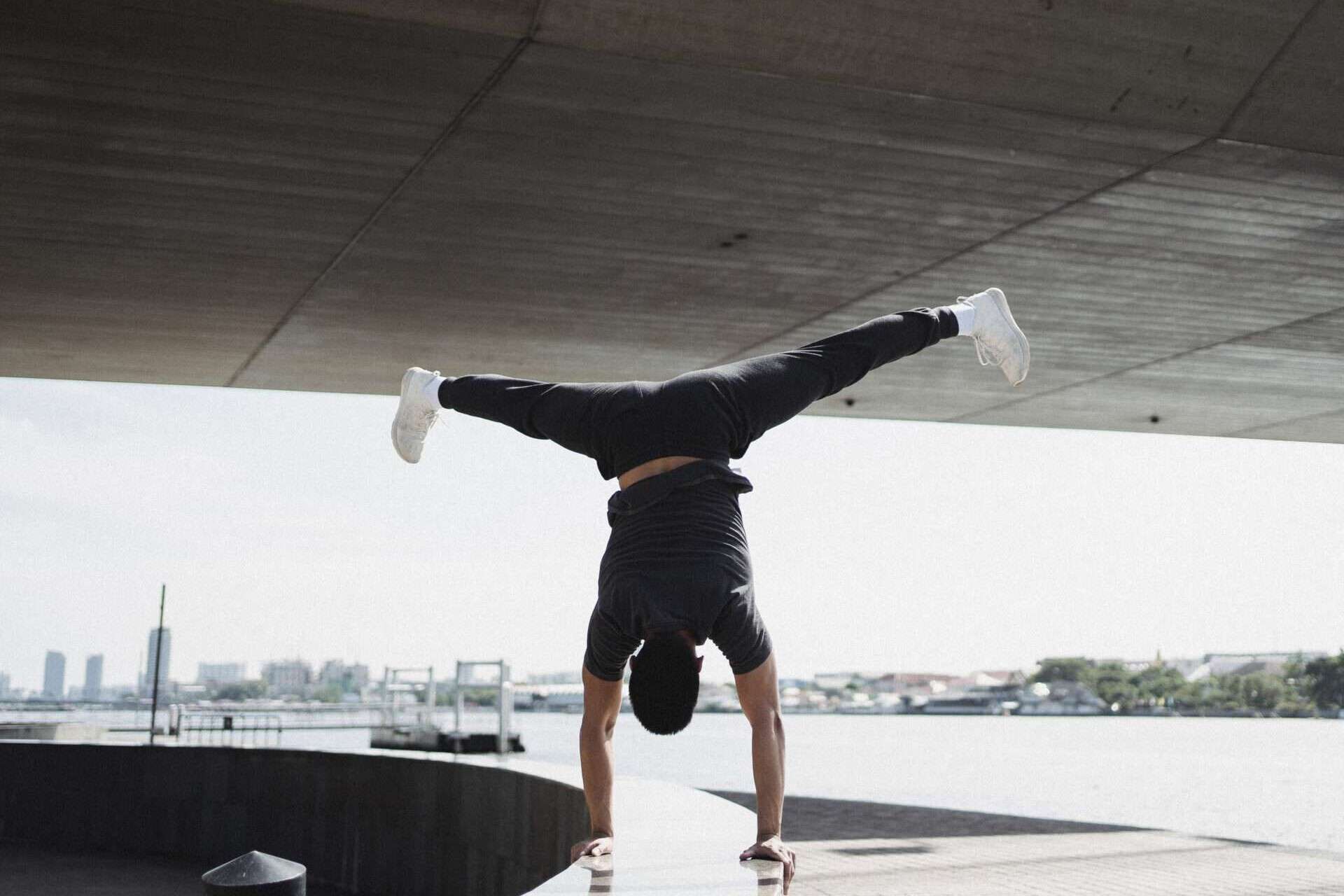 Man doing handstand splits